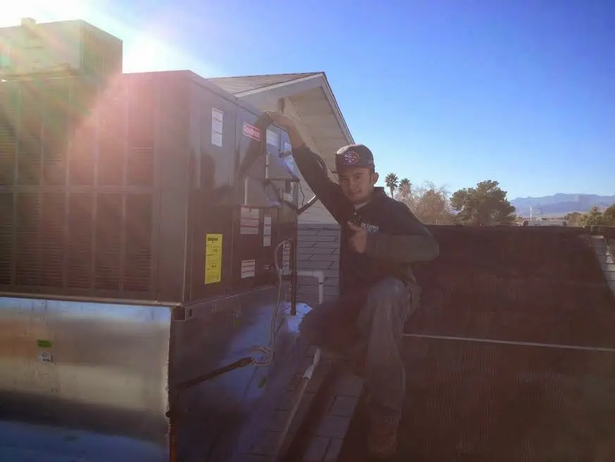 HVAC technician performing HVAC Inspection on a rooftop unit in Hilliard